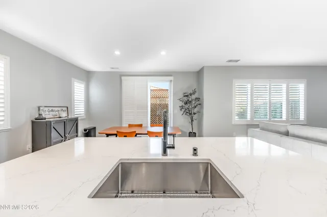 a kitchen with a sink and a large window