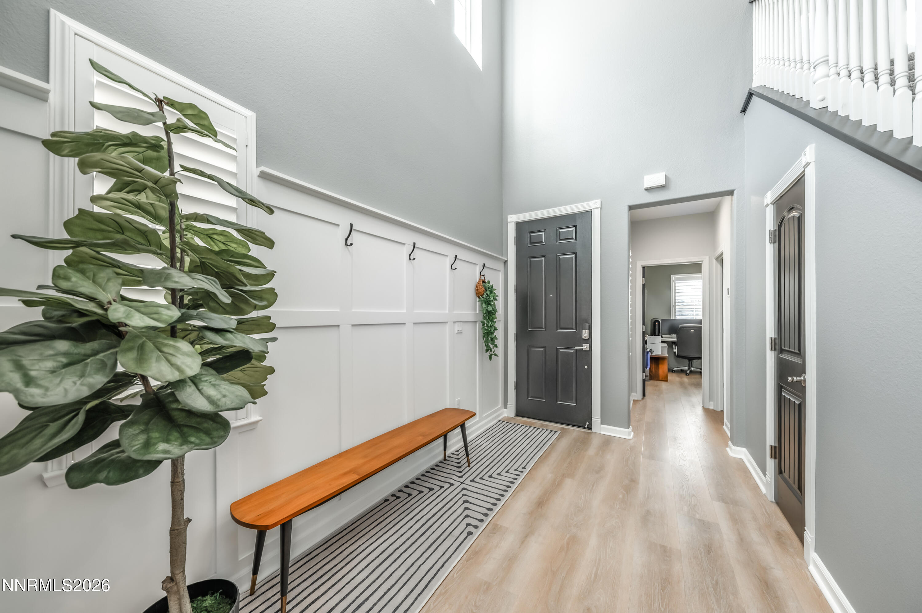 9530 Vikingholm Road Reno, NV 89521 - Photo 17 of 42 a view of a hallway with wooden floor and a potted plant