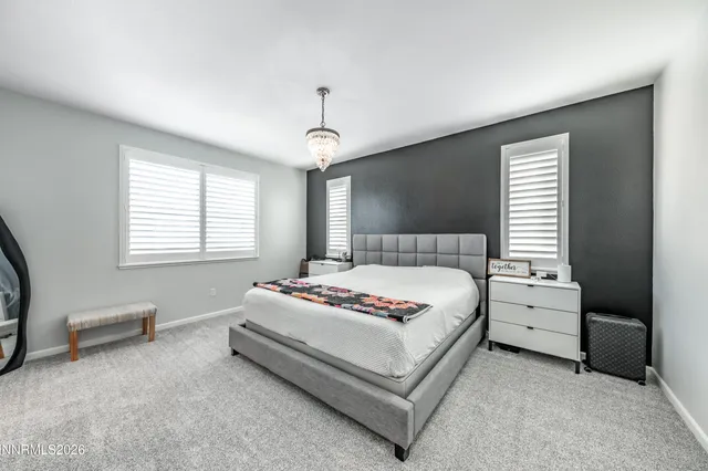 a spacious bedroom with a bed and a window