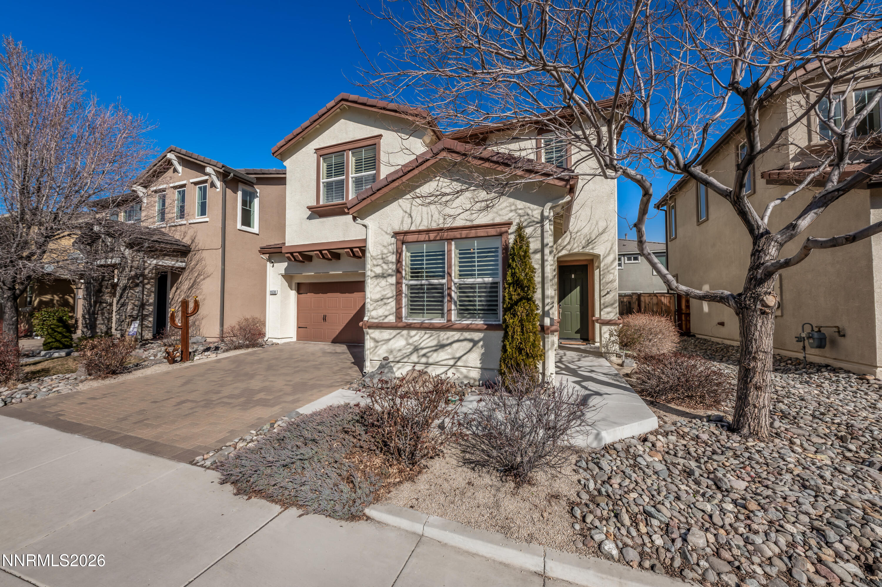 9530 Vikingholm Road Reno, NV 89521 - Photo 2 of 42 a front view of a house with a yard and garage