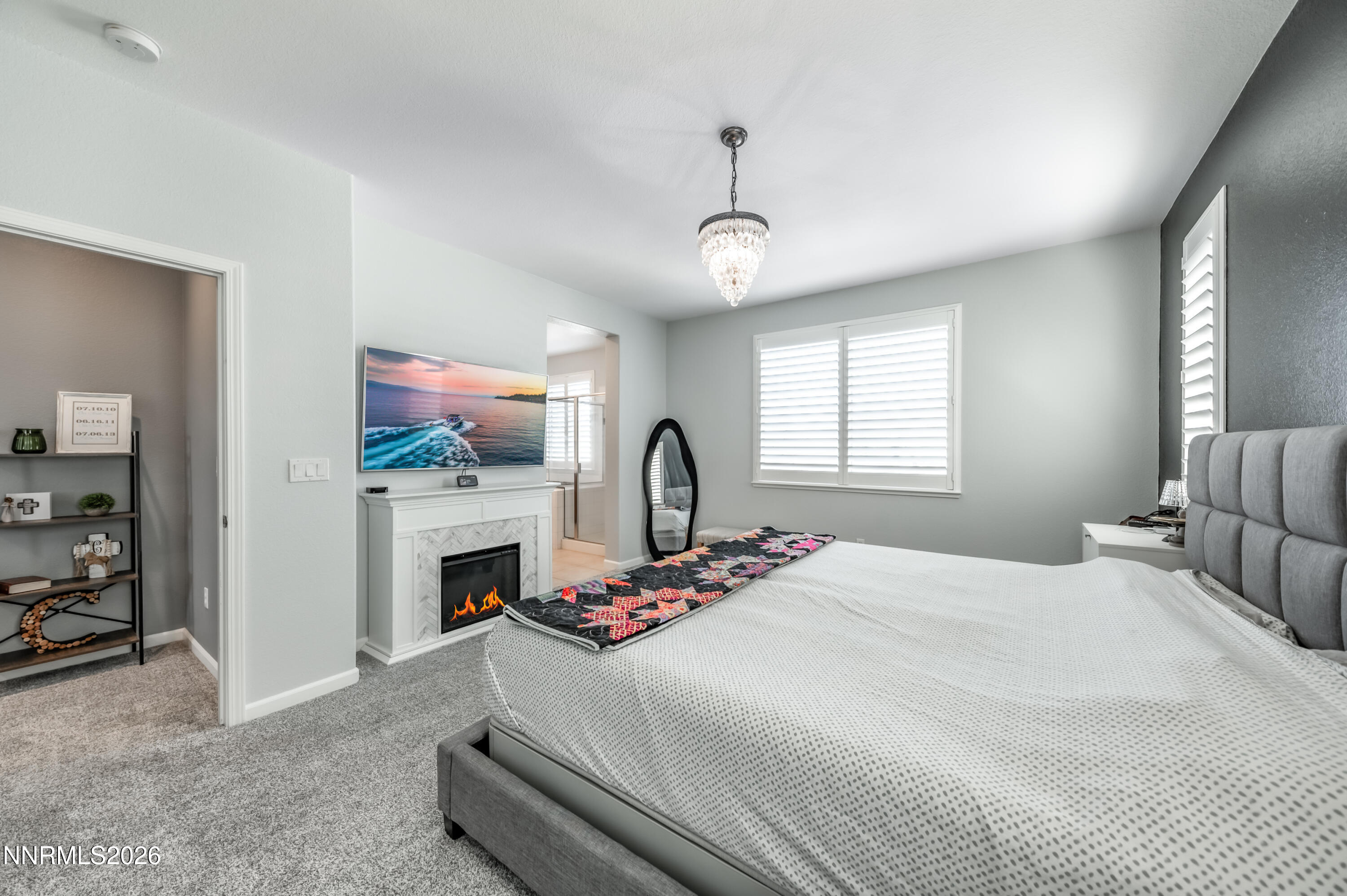 9530 Vikingholm Road Reno, NV 89521 - Photo 21 of 42 a bedroom with bed and a fireplace