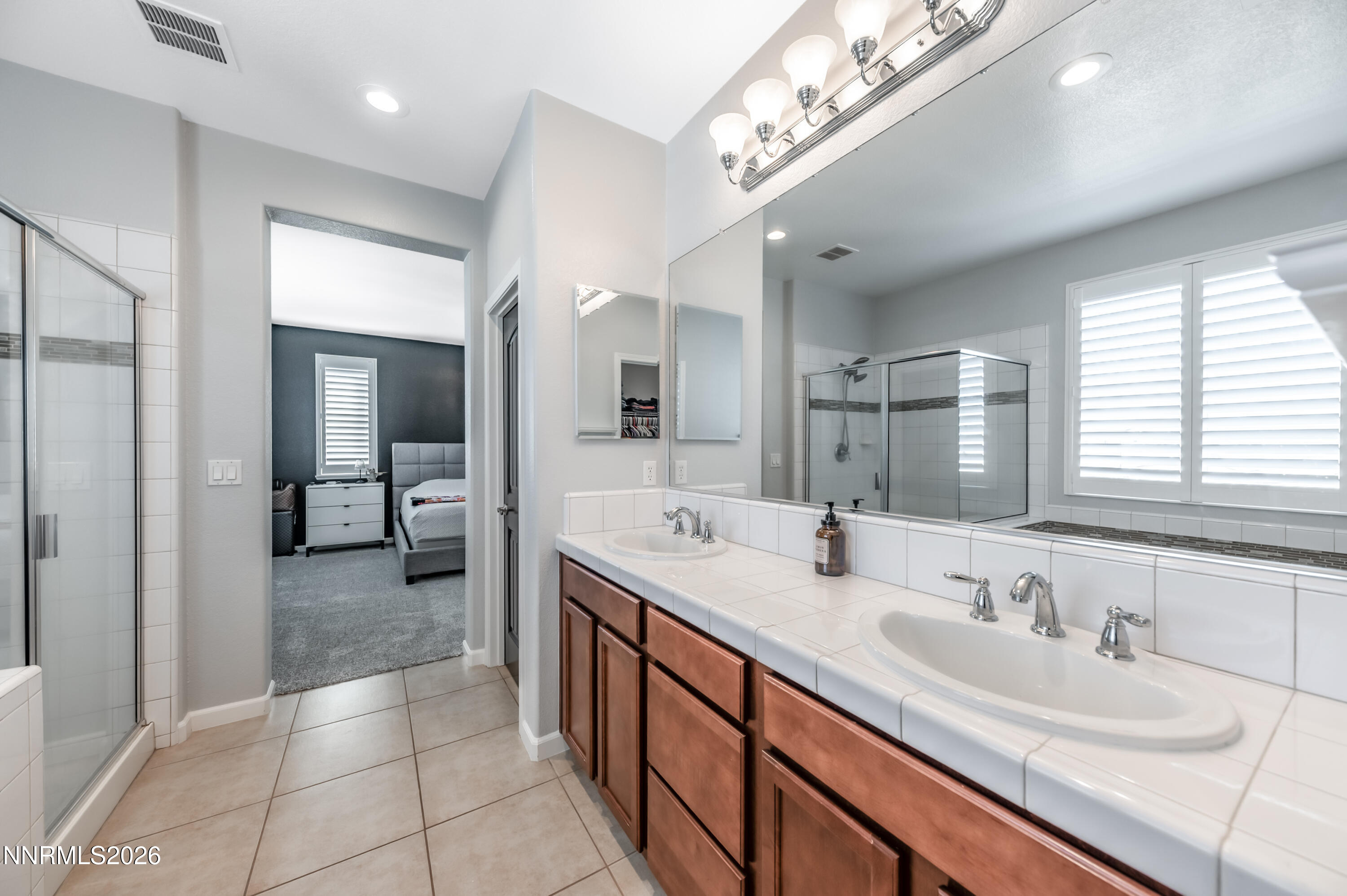 9530 Vikingholm Road Reno, NV 89521 - Photo 23 of 42 a spacious bathroom with a double vanity sink a mirror and a shower
