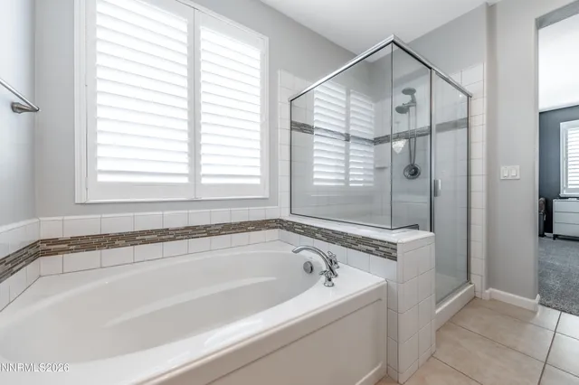 a white bath tub sitting next to a shower