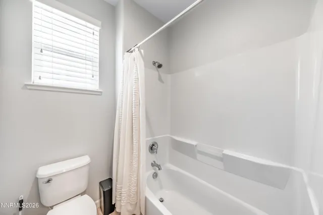 a bathroom with a toilet and a bathtub