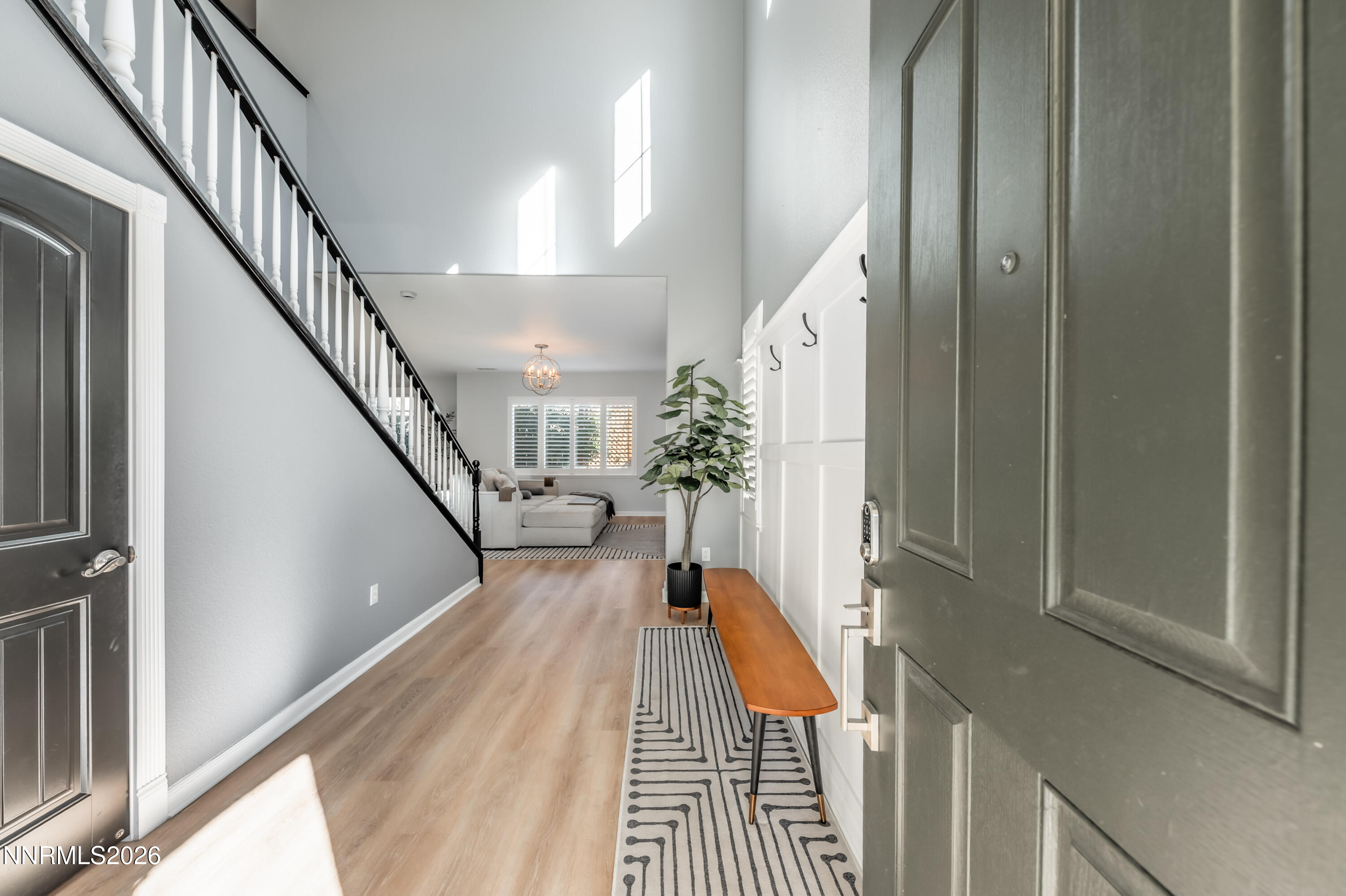 9530 Vikingholm Road Reno, NV 89521 - Photo 3 of 42 a view of a hallway with wooden floor and stairs