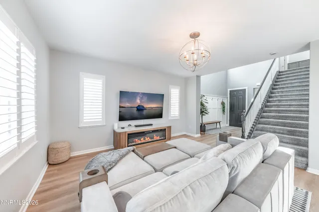 a bedroom with furniture and a flat screen tv