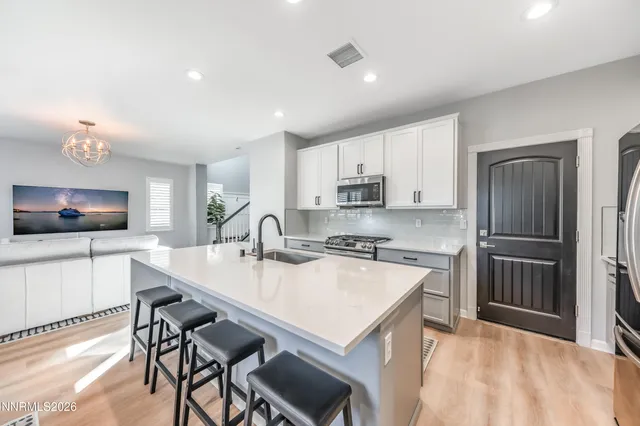 a kitchen with a stove a sink and a refrigerator