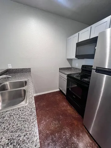 a kitchen with a refrigerator and a sink