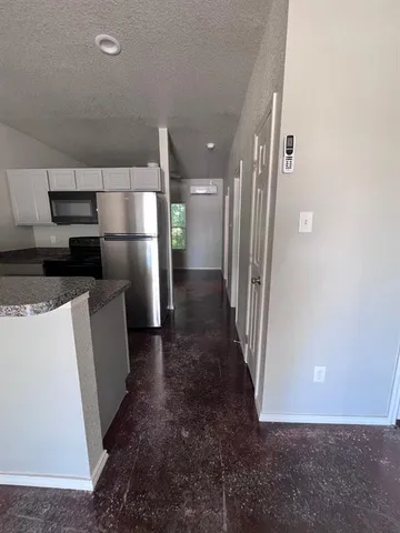 a view of a refrigerator in a kitchen