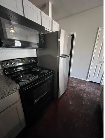 a metallic refrigerator freezer sitting in a kitchen