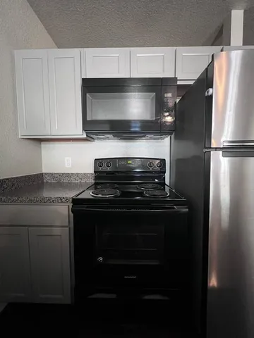 a kitchen with a stove microwave and refrigerator