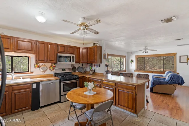 a kitchen with stainless steel appliances granite countertop a stove a sink dishwasher a microwave oven with granite countertops and cabinets