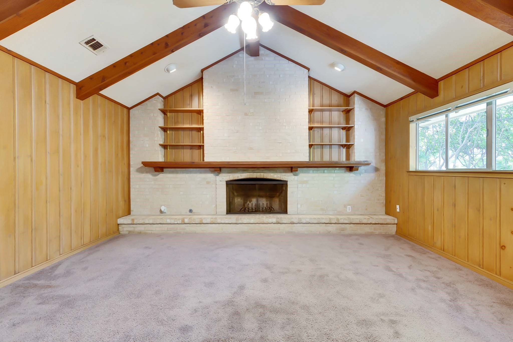 2609 Richcreek Road Austin, TX 78757 - Photo 11 of 28 a view of an empty room with a fireplace and a window