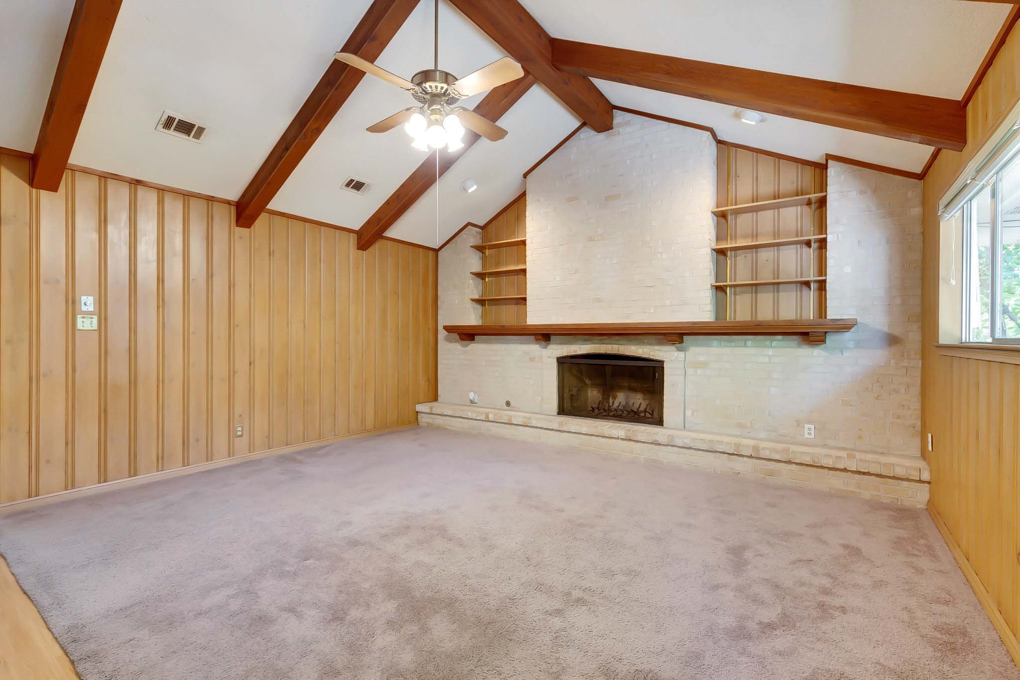 2609 Richcreek Road Austin, TX 78757 - Photo 13 of 28 a view of an empty room with a fireplace and a window