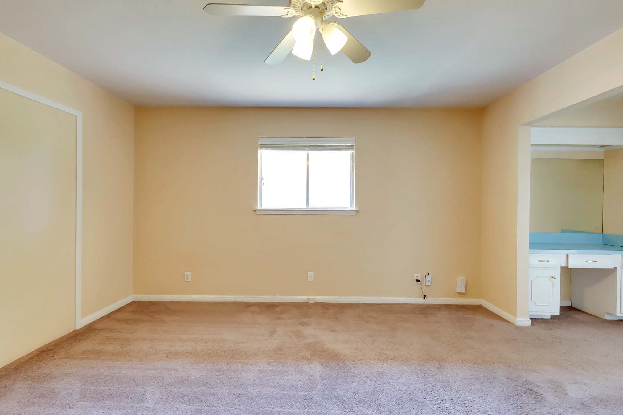 2609 Richcreek Road Austin, TX 78757 - Photo 15 of 28 an empty room with a window and a chandelier fan