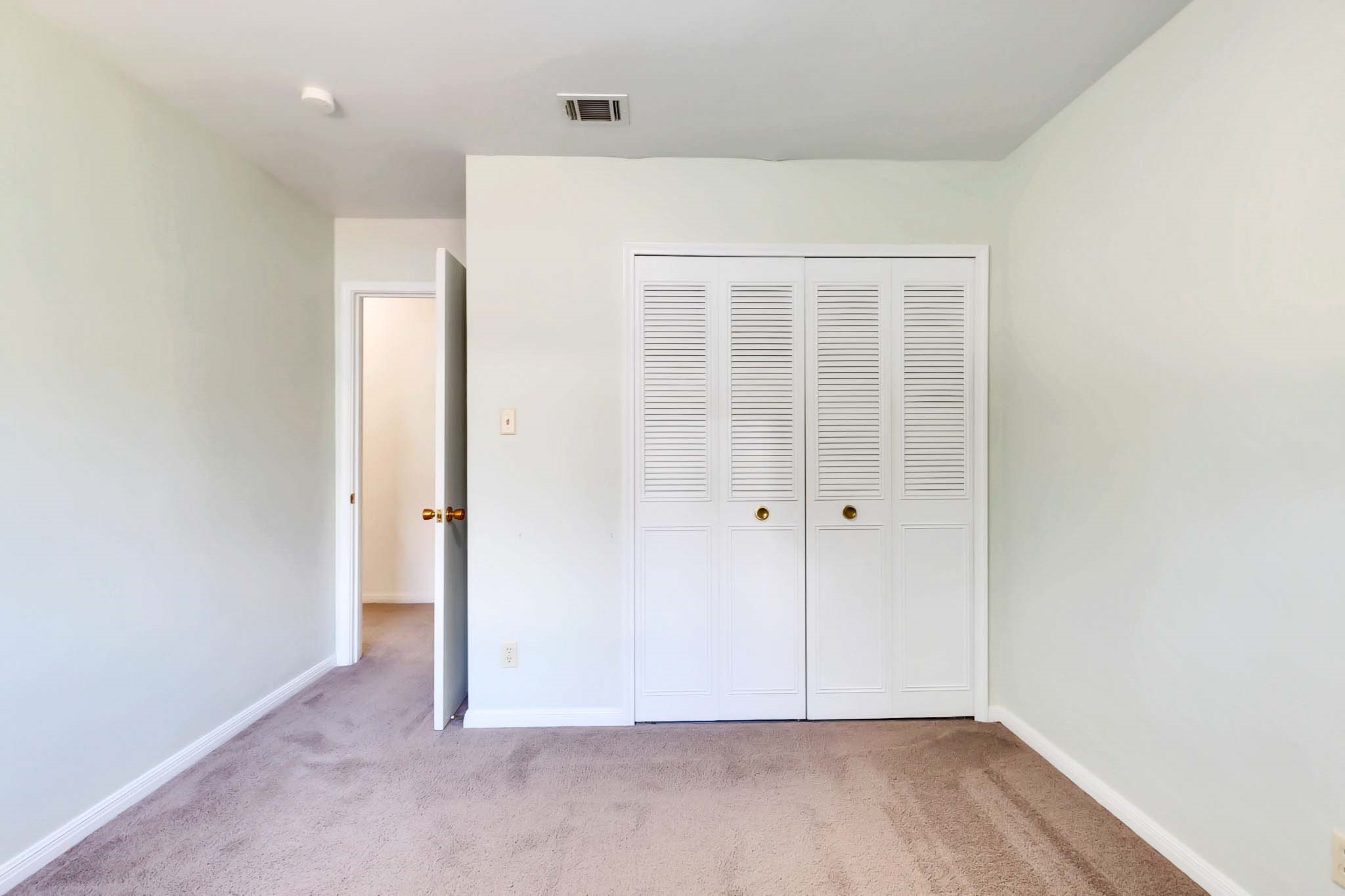2609 Richcreek Road Austin, TX 78757 - Photo 18 of 28 an empty room with wooden floor and windows