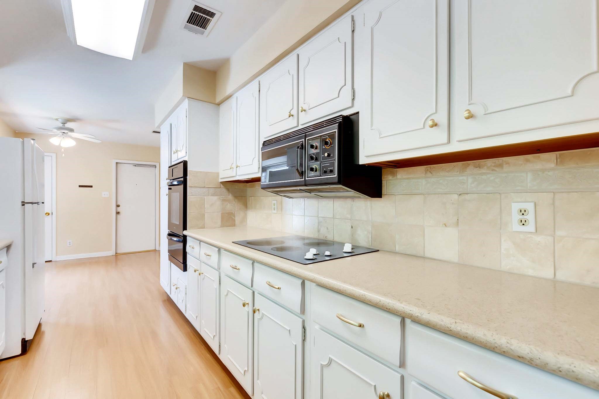 2609 Richcreek Road Austin, TX 78757 - Photo 3 of 28 a kitchen with stainless steel appliances granite countertop a sink a stove and a refrigerator