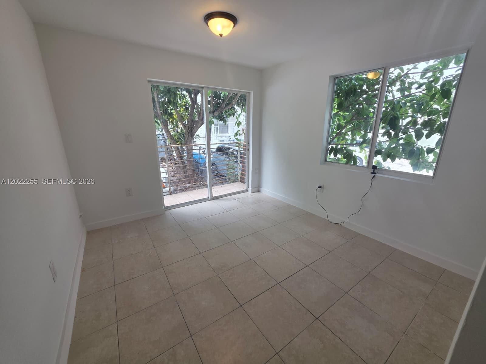 829 Southwest 3rd Street, Unit 831 Miami, FL 33130 - Photo 20 of 21 an empty room with windows