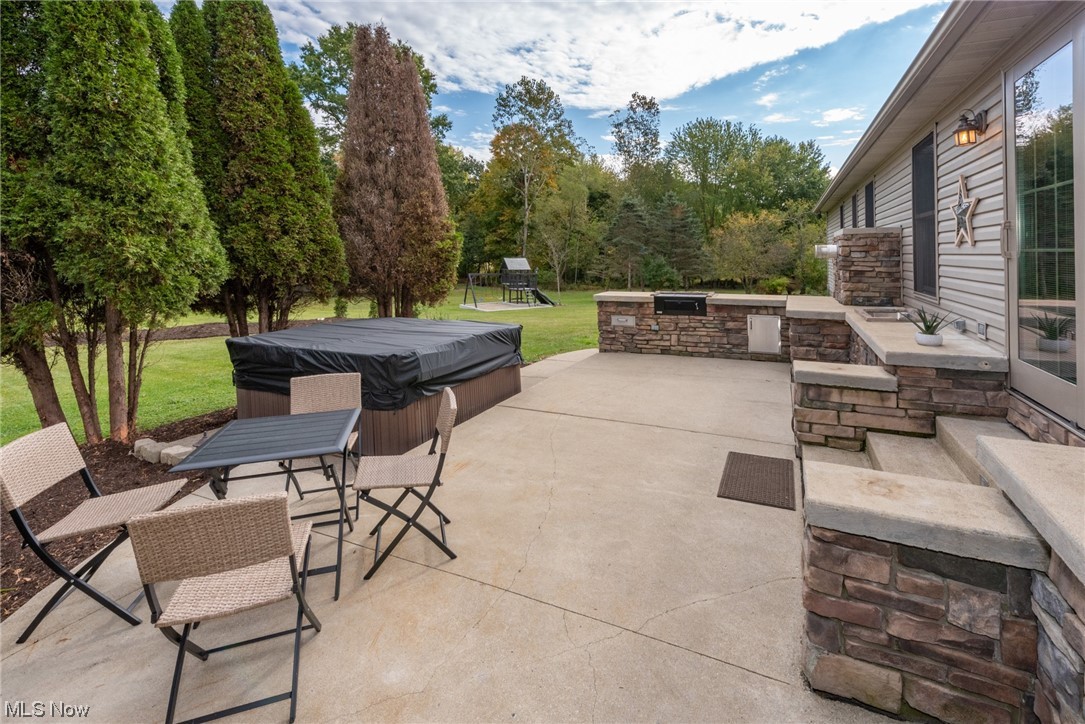 5925 Wolf Run Road Southeast Dennison, OH 44621 - Photo 28 of 35 Large patio with impressive outdoor kitchen with built in grill, sink and hot tub