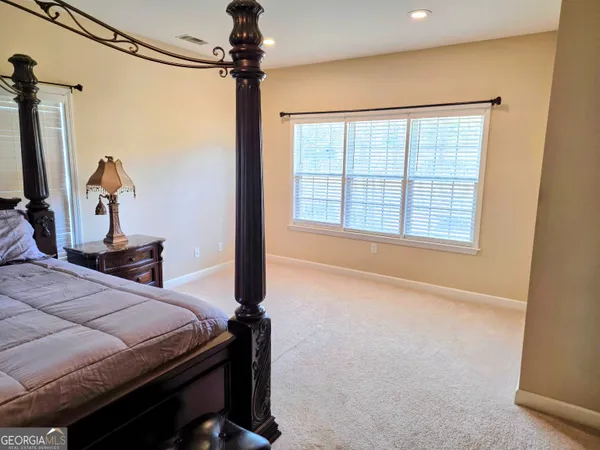 a bed room with a bed window and a flat screen tv