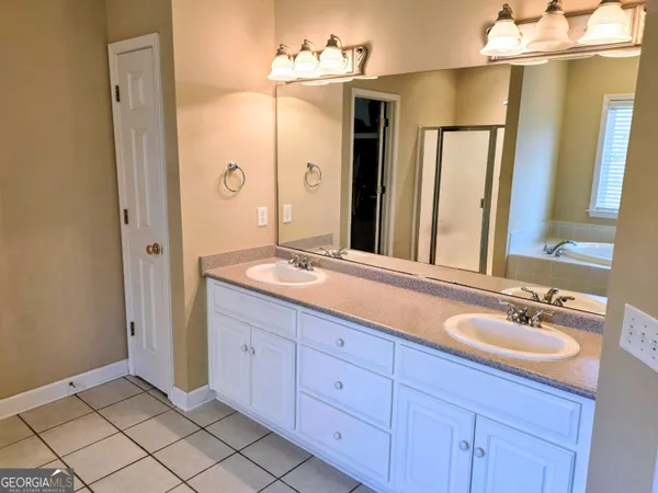a bathroom with a double vanity sink and a mirror