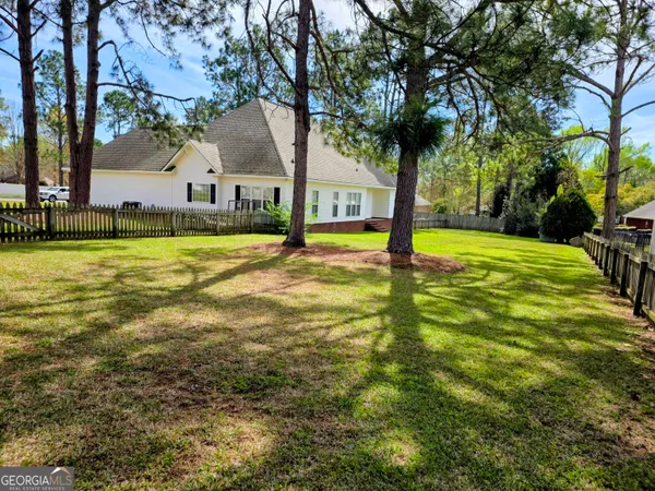 a view of a house with swimming pool and a tree
