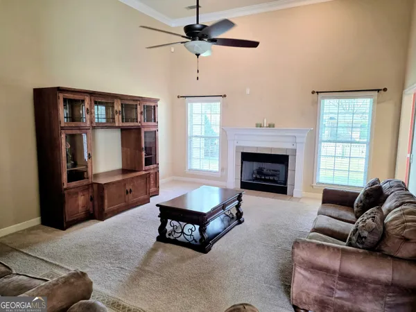 a living room with furniture a window and a fireplace