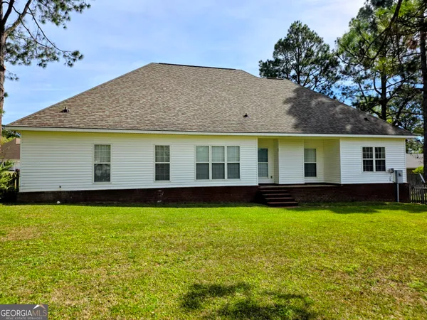 a view of a house with a swimming pool and a yard