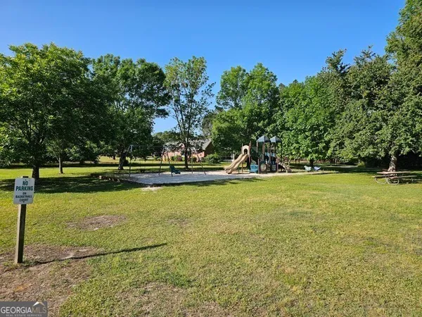 a view of yard with swimming pool and green space