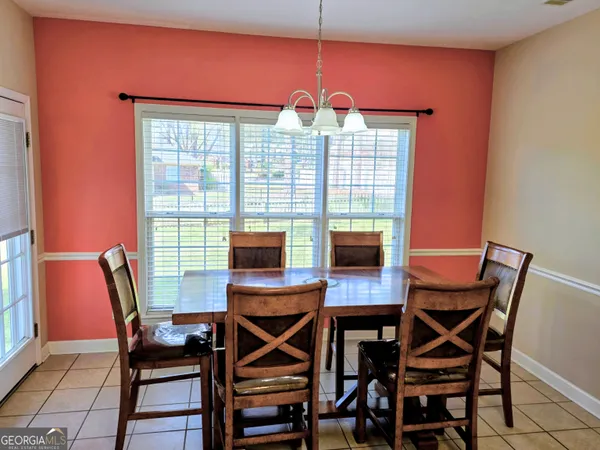 a view of a dining room with furniture and a window