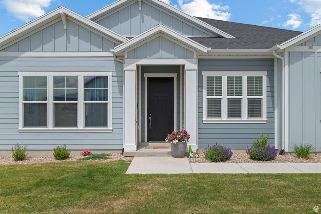 531 North Legend Way West, Unit D Mapleton, UT 84664 - Photo 4 of 42 View of front facade featuring a front lawn and board and batten siding