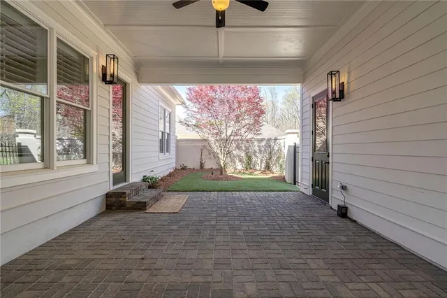 a view of empty room with window and chandelier