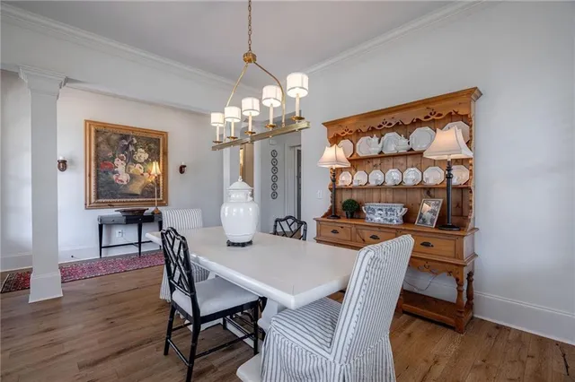a view of a dining room with furniture and chandelier
