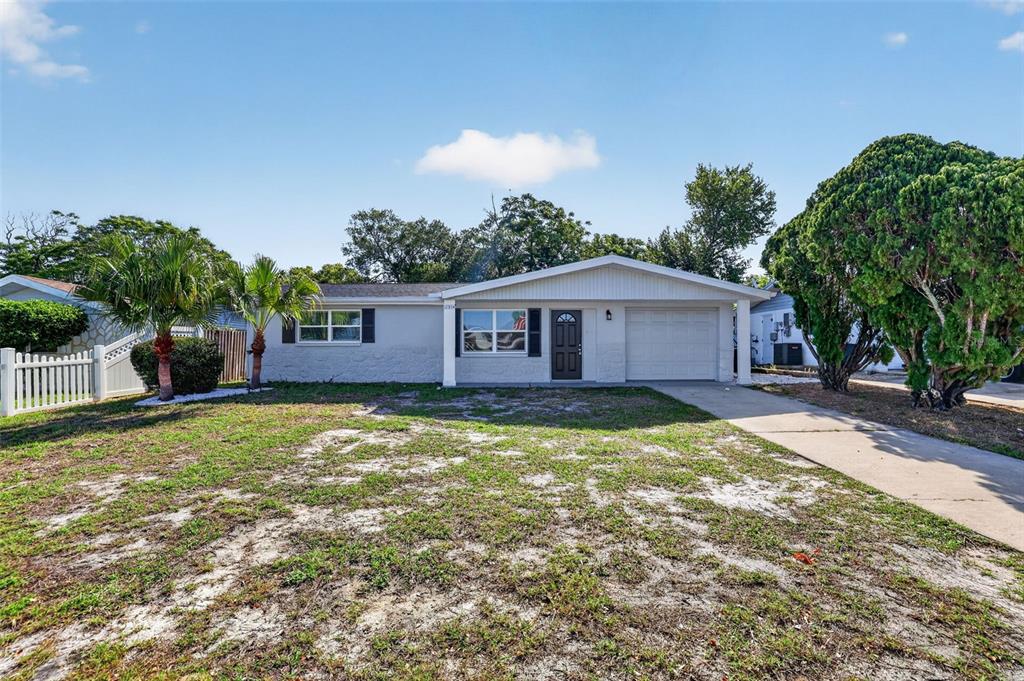 10914 Leeds Road Port Richey, FL 34668 - Photo 22 of 24 a view of a house with a yard