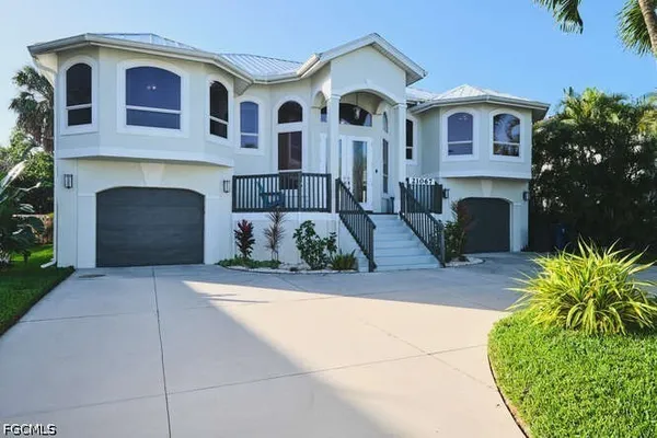a front view of a house with a yard and garage