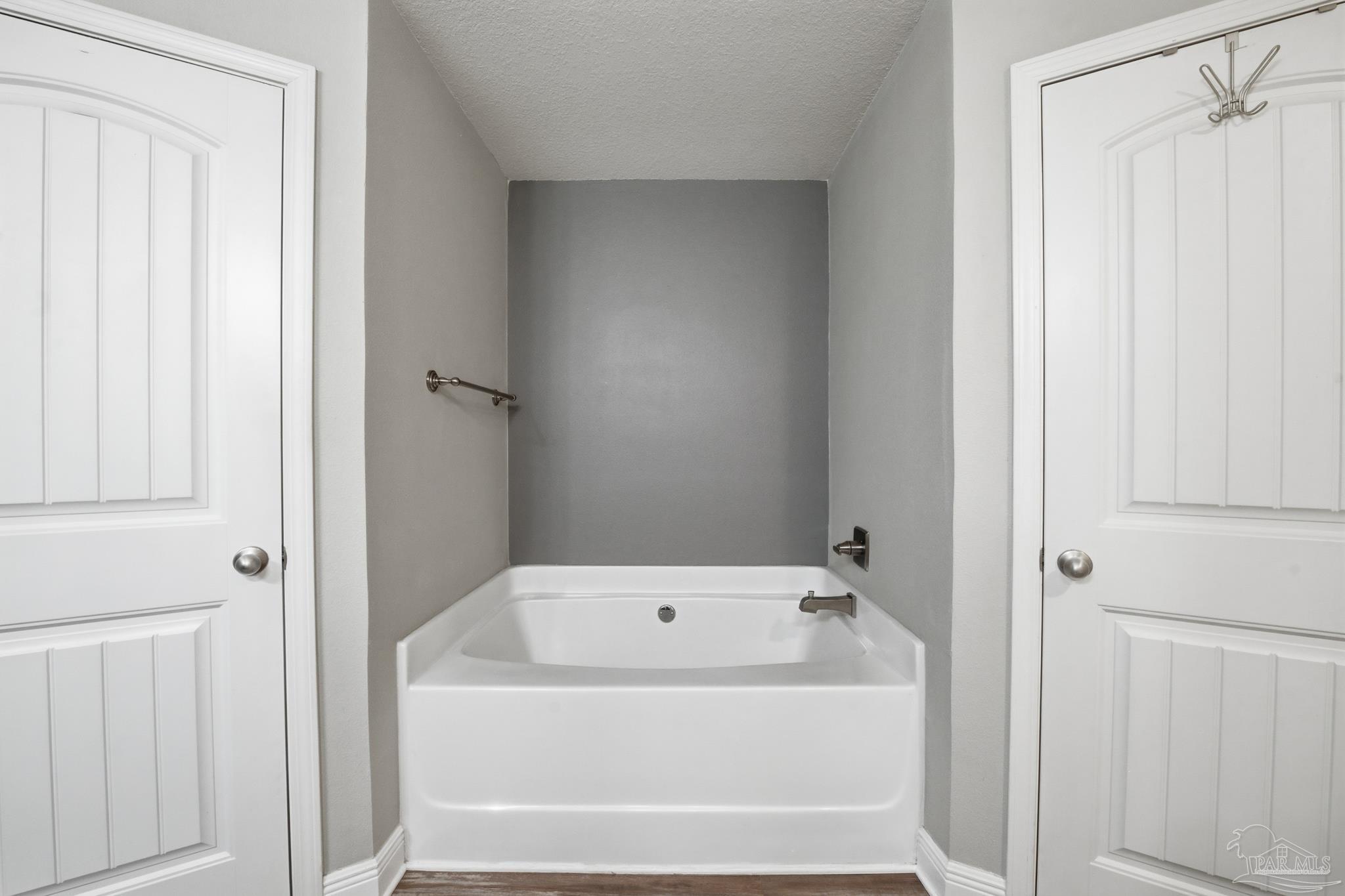 5661 Cane Syrup Circle Pace, FL 32571 - Photo 12 of 20 a white bath tub sitting next to a white cabinet