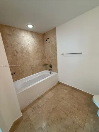 a spacious bathroom with a bathtub and shower