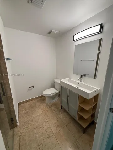 a bathroom with a sink toilet and mirror