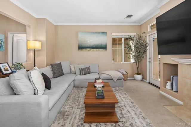 a living room with furniture a flat screen tv and a lamp