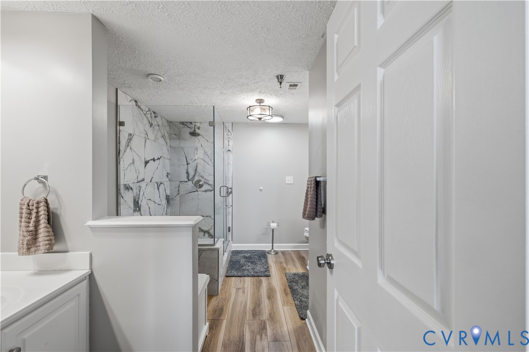 100 Taylor Street, Unit 302 Colonial Beach, VA 22443 - Photo 12 of 30 Full bath featuring vanity, a marble finish shower