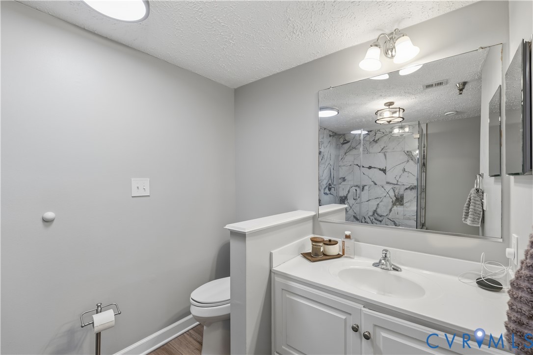 100 Taylor Street, Unit 302 Colonial Beach, VA 22443 - Photo 17 of 30 Full bath featuring vanity, a marble finish shower