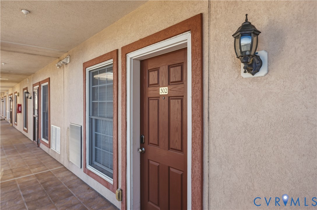 100 Taylor Street, Unit 302 Colonial Beach, VA 22443 - Photo 20 of 30 View of exterior entry with stucco siding