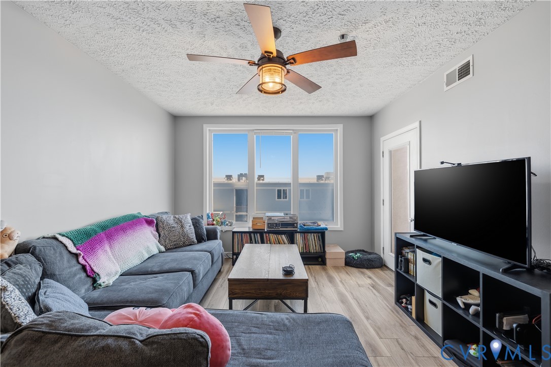 100 Taylor Street, Unit 302 Colonial Beach, VA 22443 - Photo 8 of 30 Living area with ceiling fan, light wood-style flo