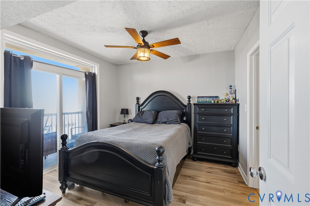 100 Taylor Street, Unit 302 Colonial Beach, VA 22443 - Photo 10 of 30 Bedroom with access to exterior, light wood-style