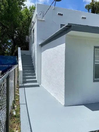 a view of a balcony with wooden floor and fence