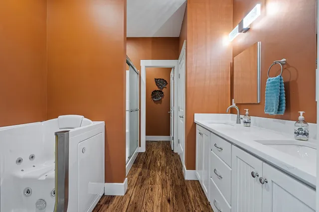 a spacious bathroom with a double vanity sink and a mirror