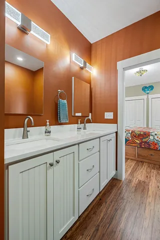 a spacious bathroom with a double vanity sink and a mirror