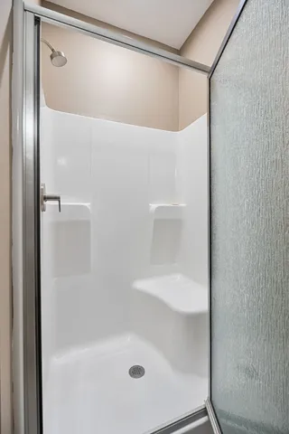 a bathroom with a glass shower door