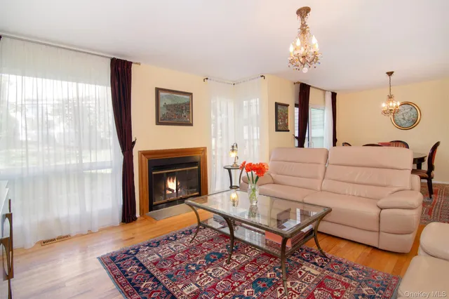 a living room with furniture a dining table and a fireplace