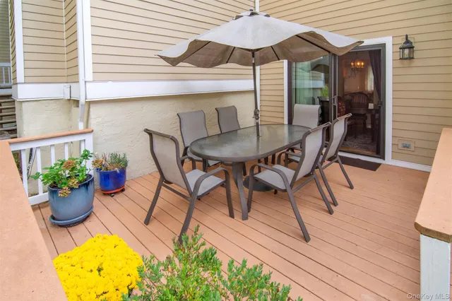 a view of a patio with a table and chairs under an umbrella